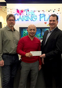 Christopher Marshall presents check to Fasy Greevy and Kevin Sunderman